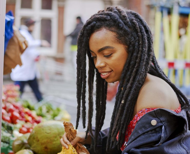 Rachel Ama buying mangos at a market