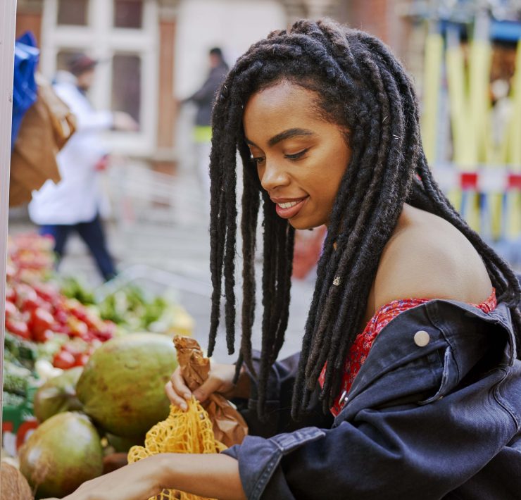 Rachel Ama buying mangos at a market