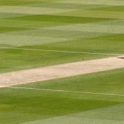 A fast bowler sends down a delivery as the batsman readys himself