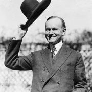 A courteous gentleman tipping his hat in a black and white era of yesteryear