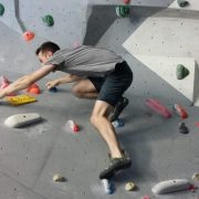 An man scales an indoor climbing wall