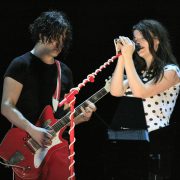 The white stripes on stage performing at a gig