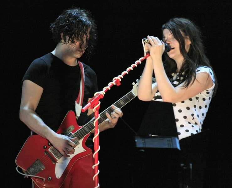 The white stripes on stage performing at a gig