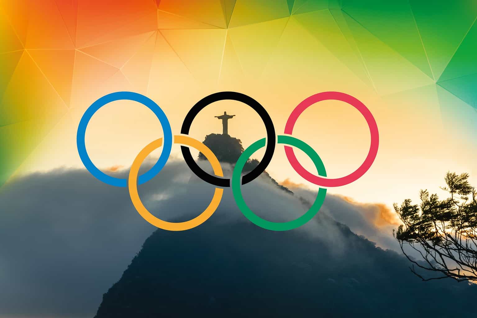 5 coloured Olympic rings with The Christ statue in Rio visible through them