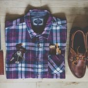 A neatly folded and organsied set of shirt shoes wallet camera keys ciggies and lighter!