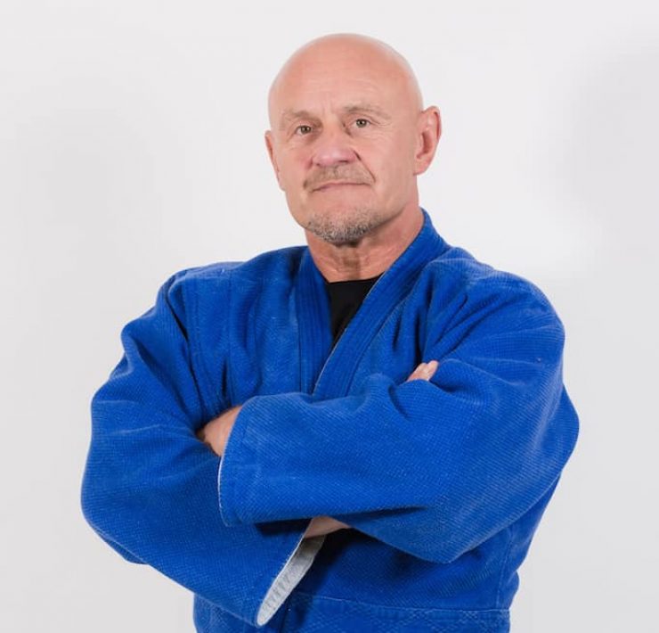 kevin O Hagan arms crossed dressed in his martial arts outfit and black belt