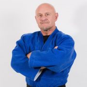 kevin O Hagan arms crossed dressed in his martial arts outfit and black belt