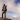 record breaking Adventurer Ash Dykes stands on top of a mountain in Madagascar. A chicken's head can be seen poking out of his rucksack. Pic taken by Suzanna Tierie