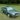 A green Audi Quattro sits on a patch of grass