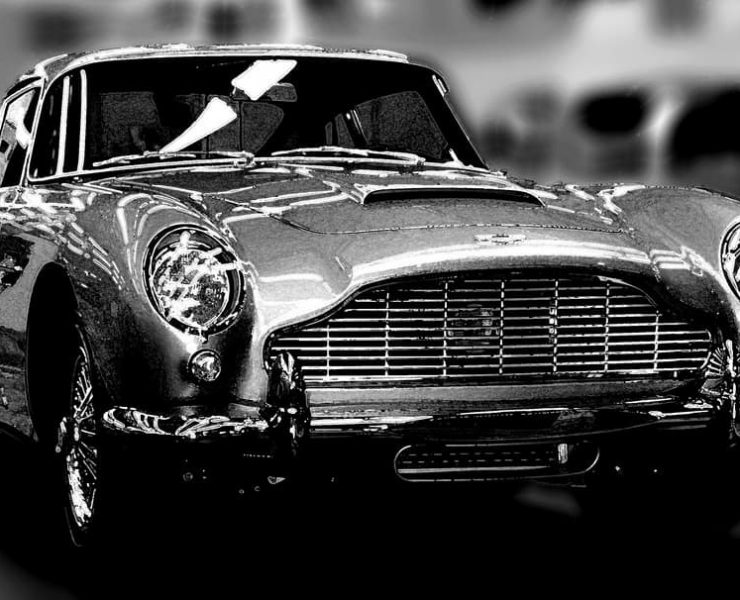 A shiny Astin Martin DB5 photographed in black and white