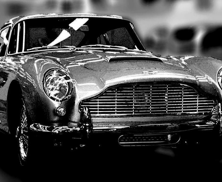A shiny Astin Martin DB5 photographed in black and white