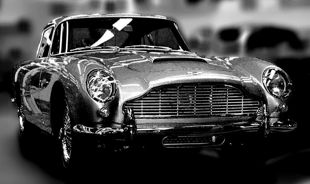 A shiny Astin Martin DB5 photographed in black and white