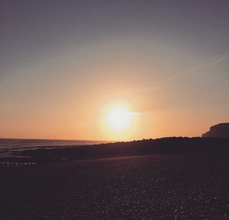 Picture of the sun setting in Brighton over the sea