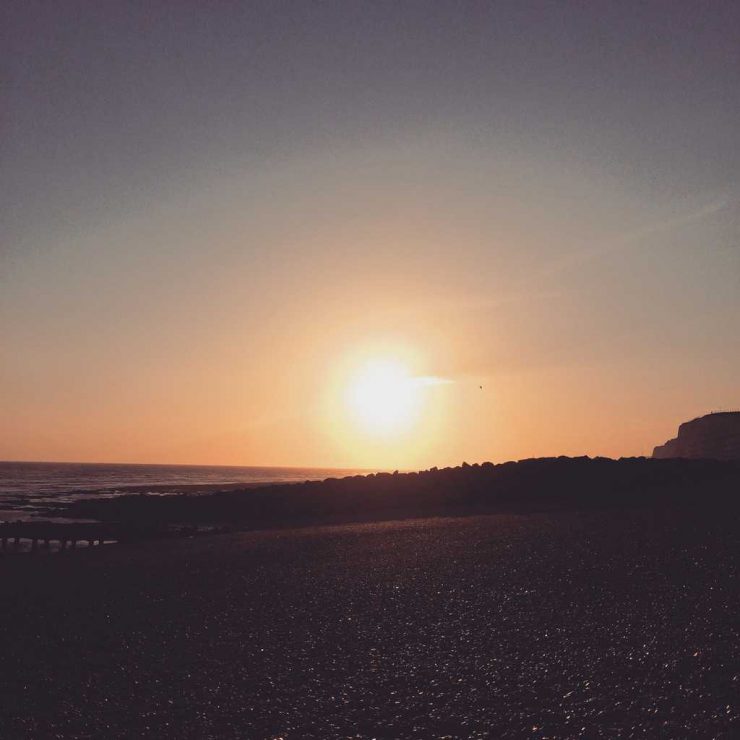 Picture of the sun setting in Brighton over the sea