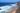 A beautiful beach viewed from a cliff top with sets of waves rolling in