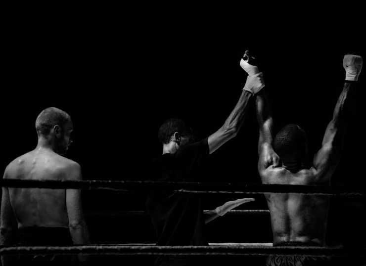 Two boxers at the end of the fight as the winner is announced - black and white