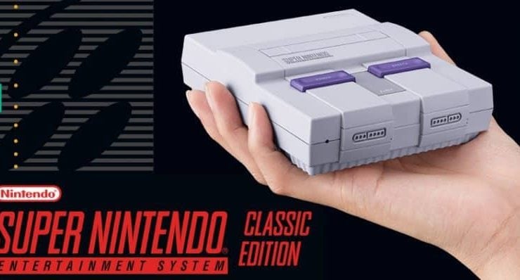 Mini Nintendo SNES classic held in the palm of someones hand