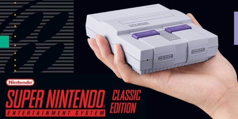 Mini Nintendo SNES classic held in the palm of someones hand
