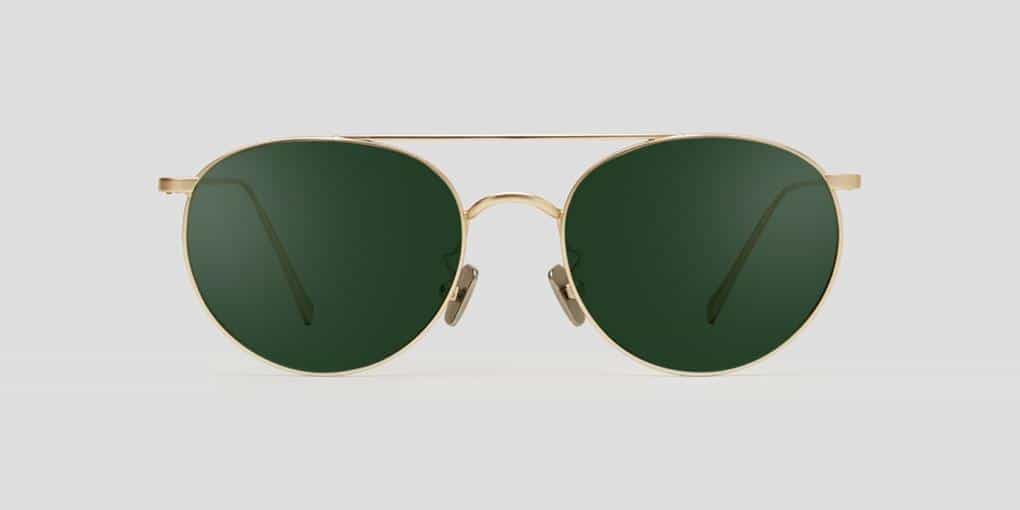 Gold rimmed sunglasses with a dark lens