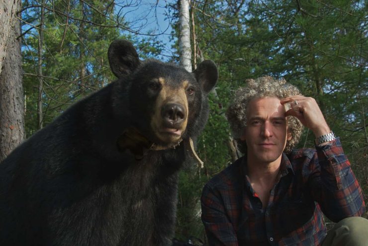 Gordon Buchanan sat alongside a Black Bear