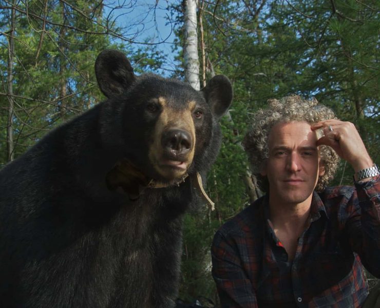 Gordon Buchanan sat alongside a Black Bear