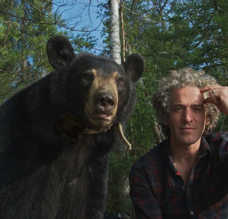 Gordon Buchanan sat alongside a Black Bear