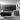 A stylish minimally furnished living area predominantly grey