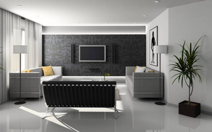A stylish minimally furnished living area predominantly grey