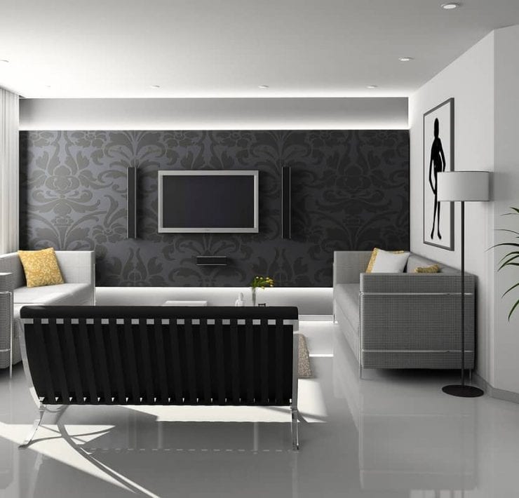 A stylish minimally furnished living area predominantly grey