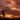 boy doing overhead kick on the beach with a sunset behind
