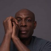 Frank Bruno staring at the camera hands clasped