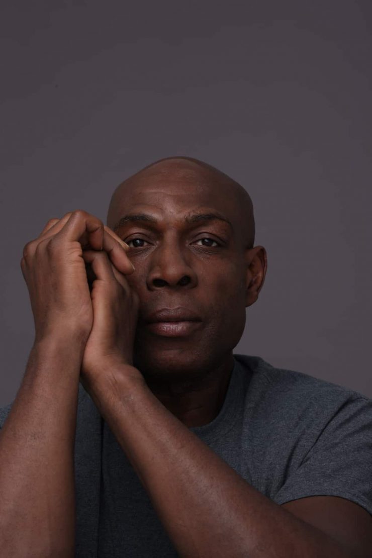 Frank Bruno staring at the camera hands clasped