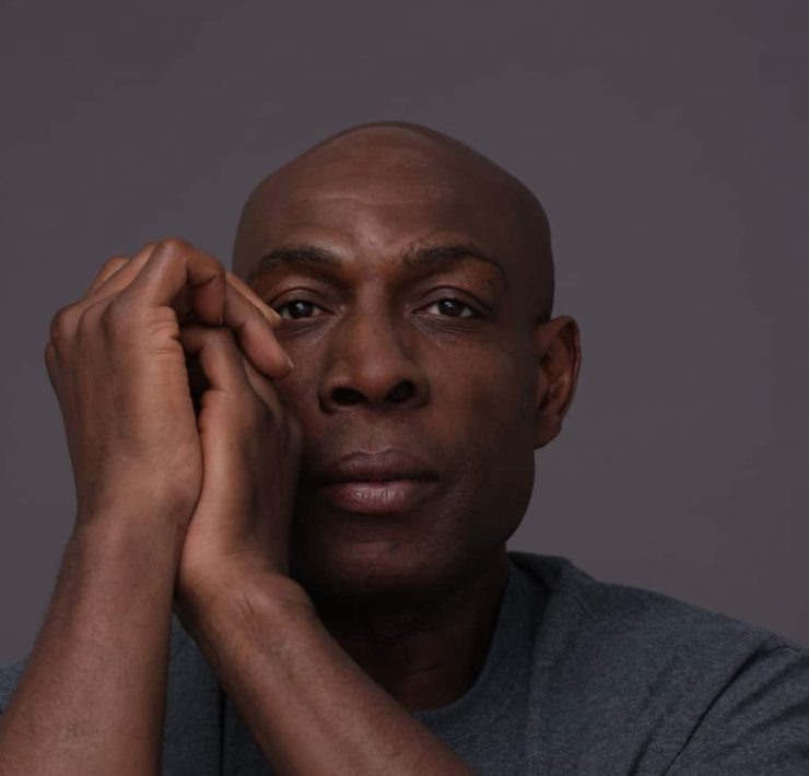 Frank Bruno staring at the camera hands clasped