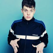 comedian Ed Night poses with hands out in front of his body