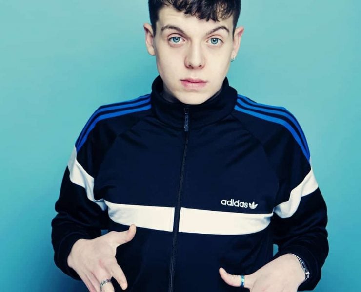 comedian Ed Night poses with hands out in front of his body