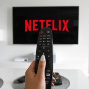 woman pointing remote at netflix
