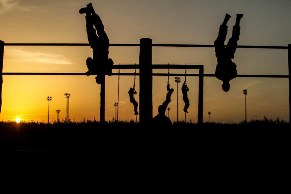 Soldiers negotiate an obstacle course at dusk