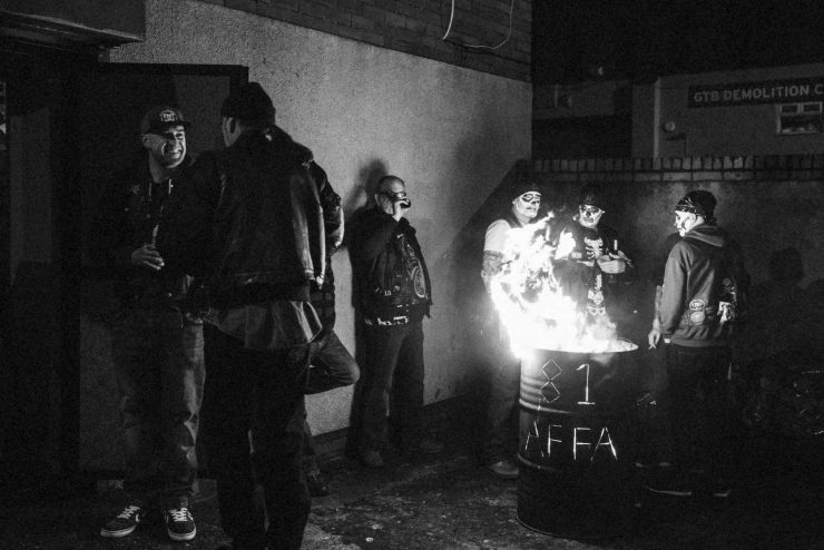 Hell's Angels members standing around a fire in a barrel by photographer Andrew Shaylor
