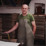 A papermaker stood in his factory