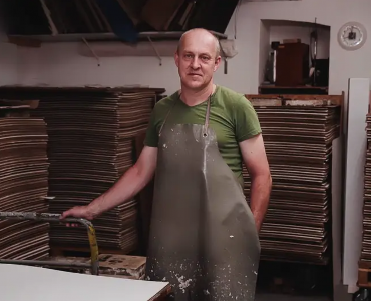 A papermaker stood in his factory