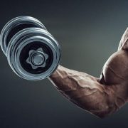 A muscular man holding a dumbell