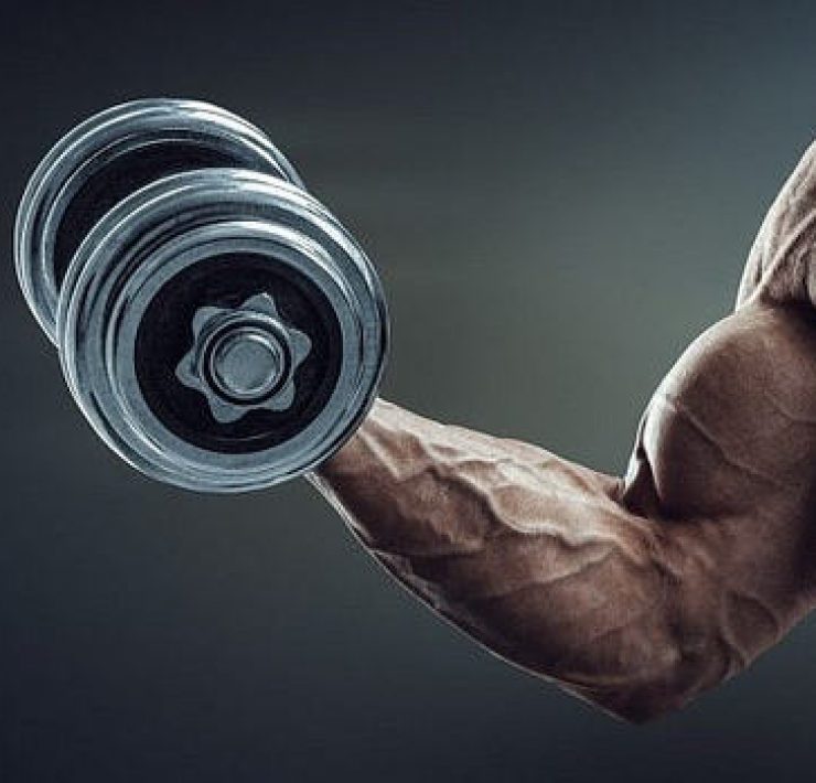 A muscular man holding a dumbell