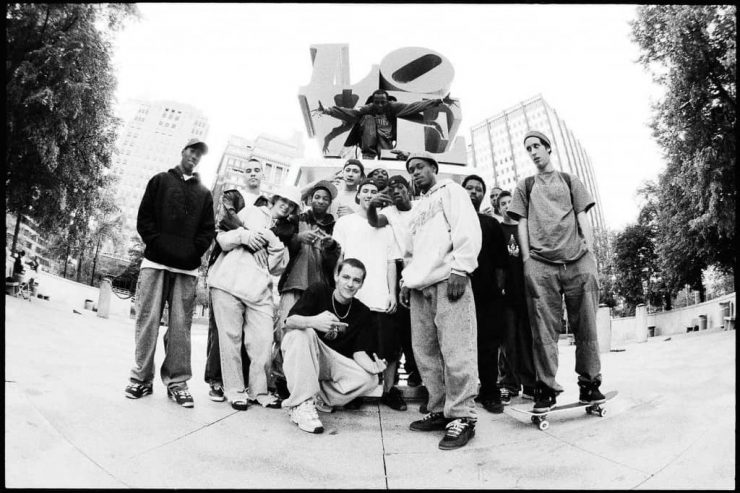 A group of young men in 90s menswear attire