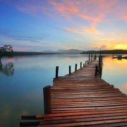 A wooden pier leading out to a lake