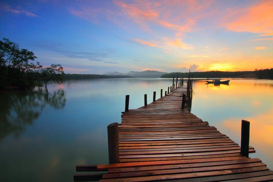 A wooden pier leading out to a lake