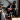 man with face painted in spooky way playing guitar in front of woman