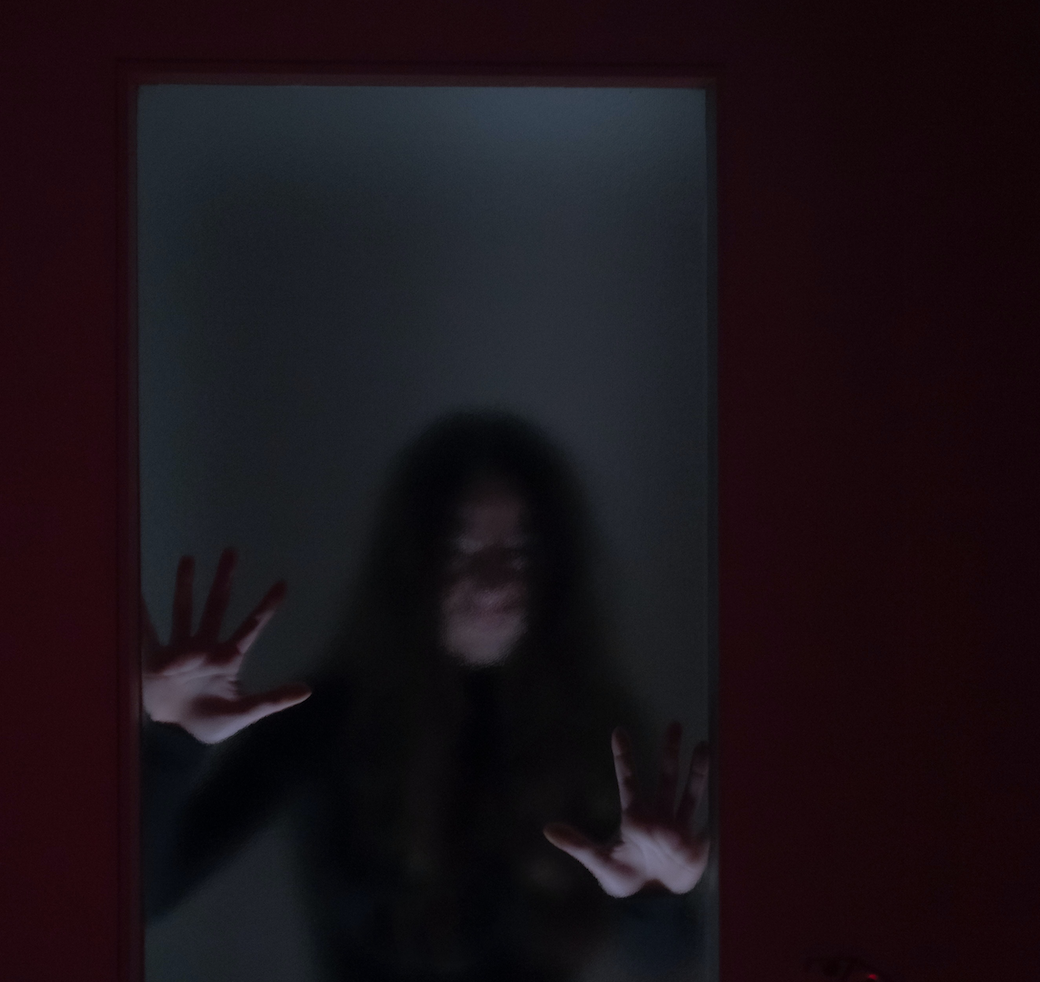 spooky woman behind window