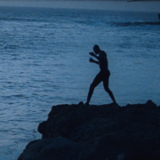 Kherou the wrestler shadowboxing on rocks