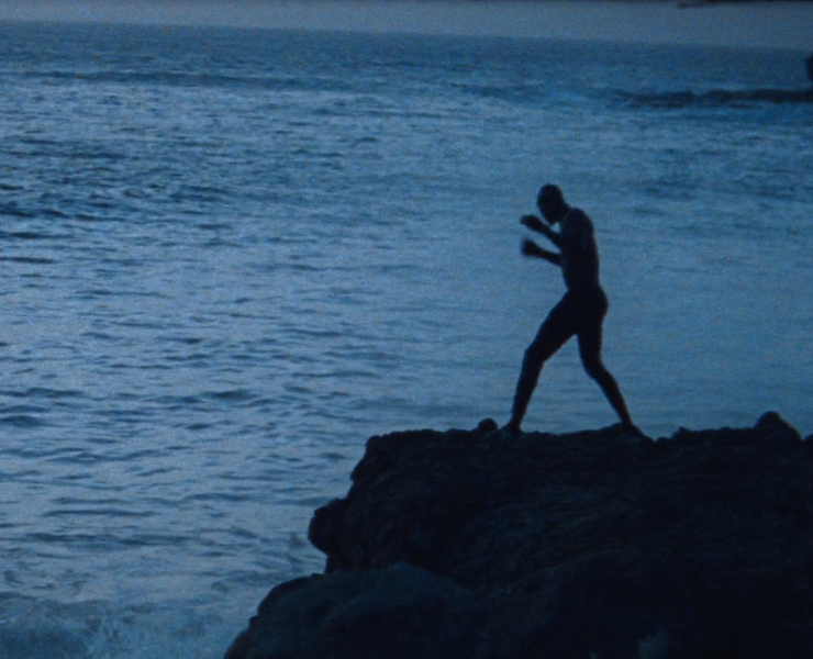 Kherou the wrestler shadowboxing on rocks