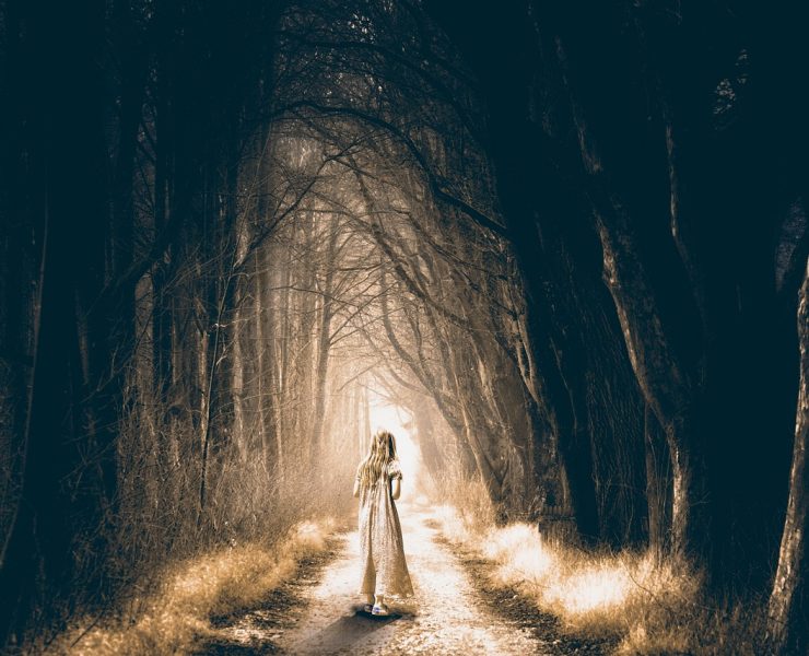 ghostly girl walking into forest